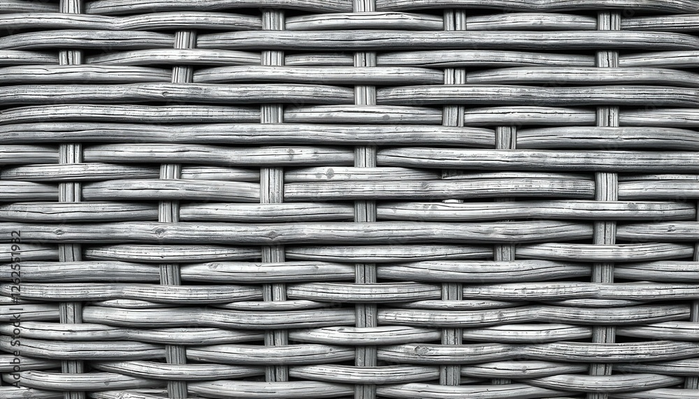 Close up of woven wicker texture in shades of gray highlighting the intricate weave pattern Close up of woven wicker texture in shades of gray highlighting the intricate weave pattern