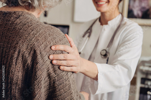 Doctor Supporting an Elderly Patient Showing Care and Compassion in a Clinical Setting