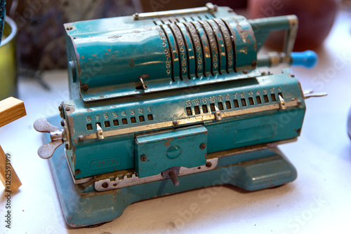 Berlin, Germany - July 01, 2024: Vintage adding machine on white surface