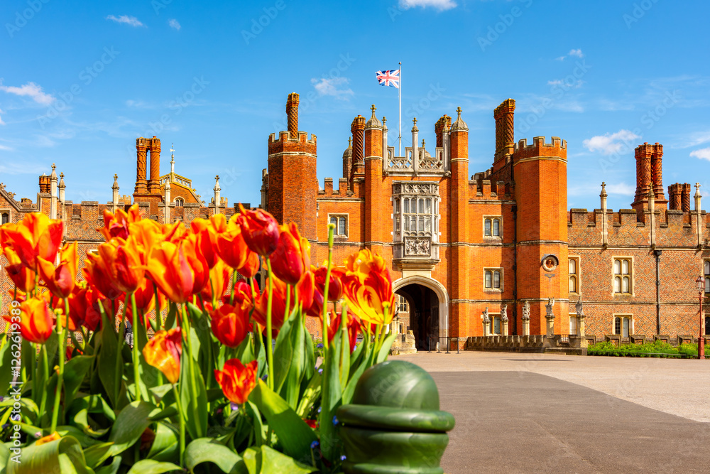 Tudor gatehouse of Hampton Court palace and spring tulips in Richmond, London, UK