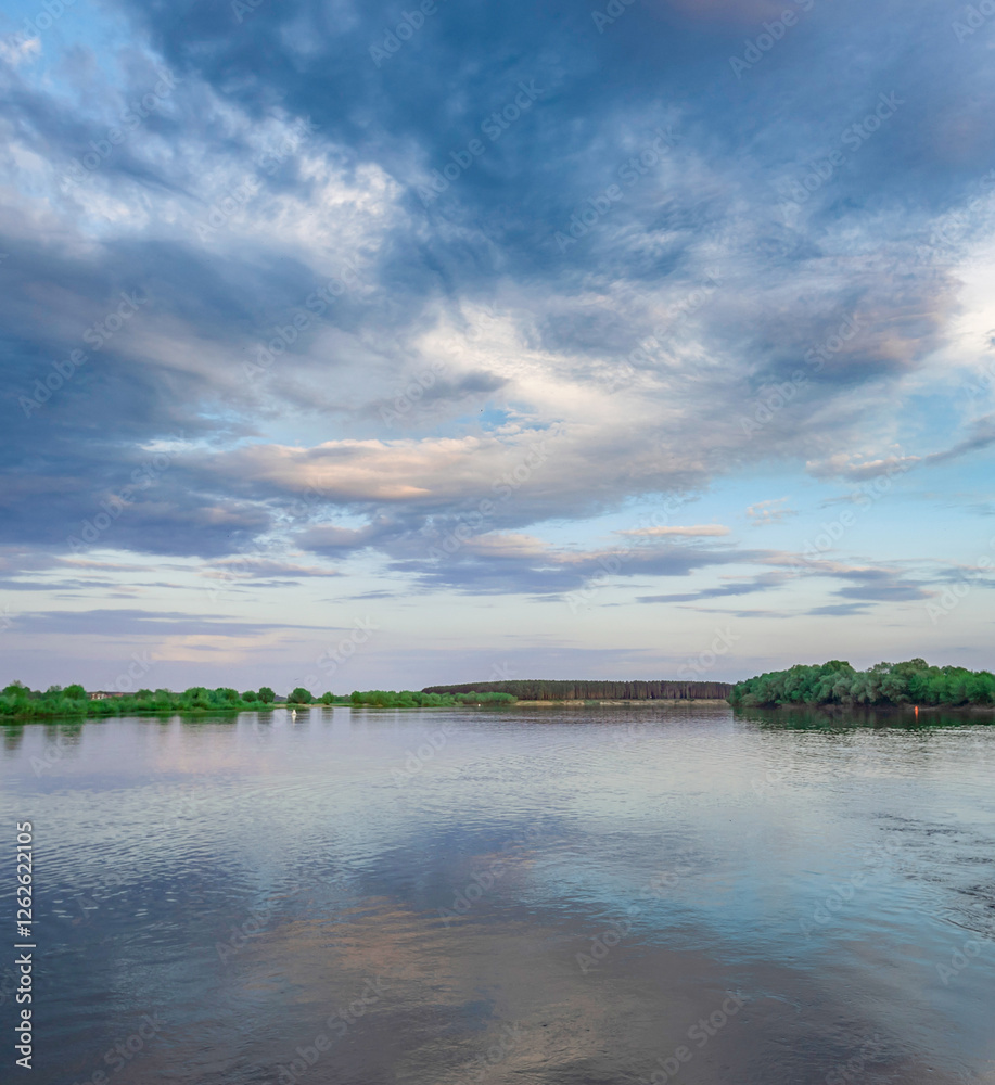 Fototapeta premium Calm lake with a cloudy sky in the background