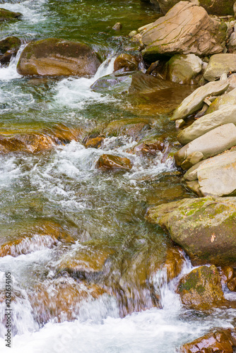 Obraz na płótnie rapid water stream among rocks and stones. beautiful nature background in romanian mountains. closeup view from above w salonie