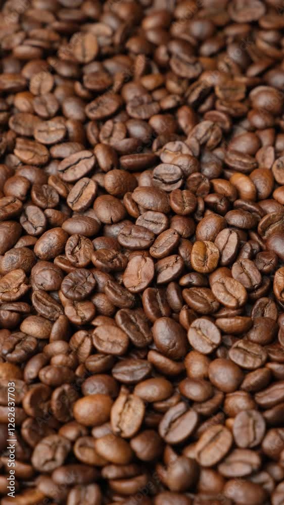 Rotating a pile of caffeine-free decaf coffee beans vertical close-up Rotating a pile of caffeine-free decaf coffee beans vertical close-up