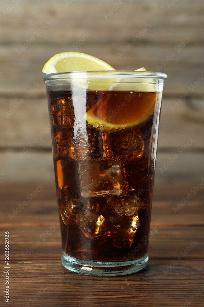 Refreshing iced cola with lemon slices on wooden table, closeup Refreshing iced cola with lemon slices on wooden table, closeup