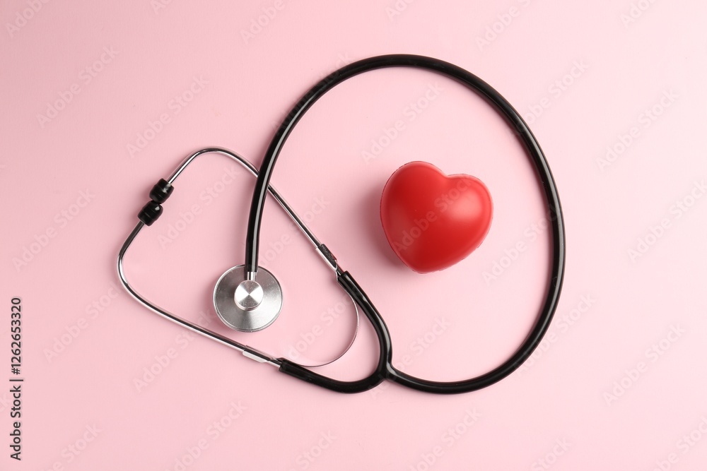 Cardiology. Stethoscope and red decorative heart on pale pink background, flat lay Cardiology. Stethoscope and red decorative heart on pale pink background, flat lay