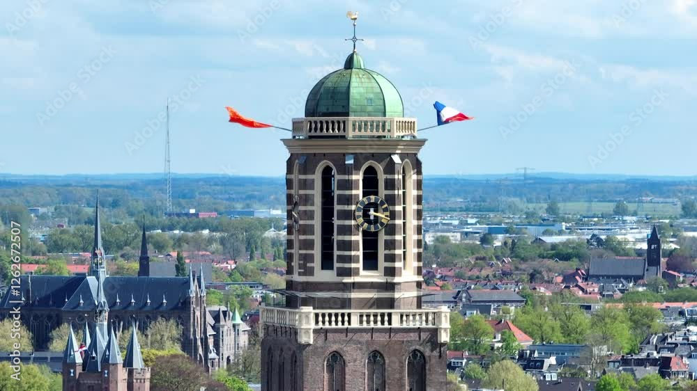 Zwolle Peperbus church tower with Dutch and Orange flags in the wind during Koningsdag 
