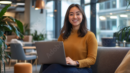 Young professional working on laptop in modern office space urban environment lifestyle image cheerful perspective