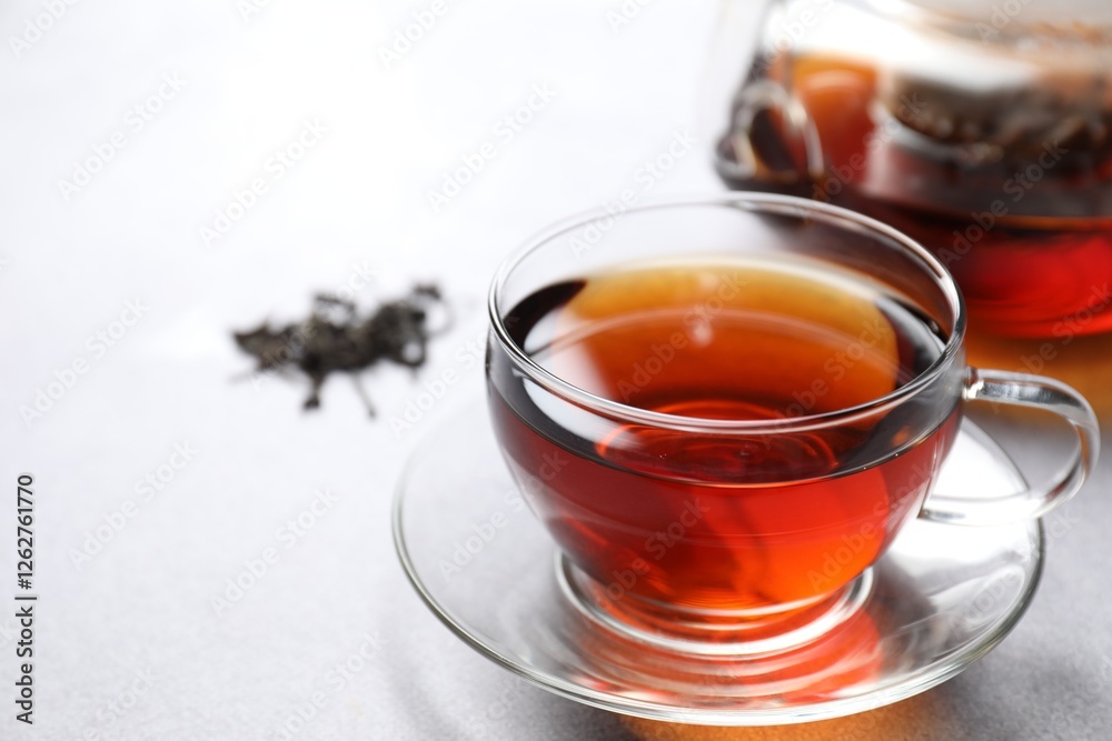 Aromatic black tea in cup on light table, closeup. Space for text Aromatic black tea in cup on light table, closeup. Space for text