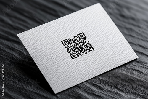 Blank white business card mockup with micro-embossed QR code design on textured surface