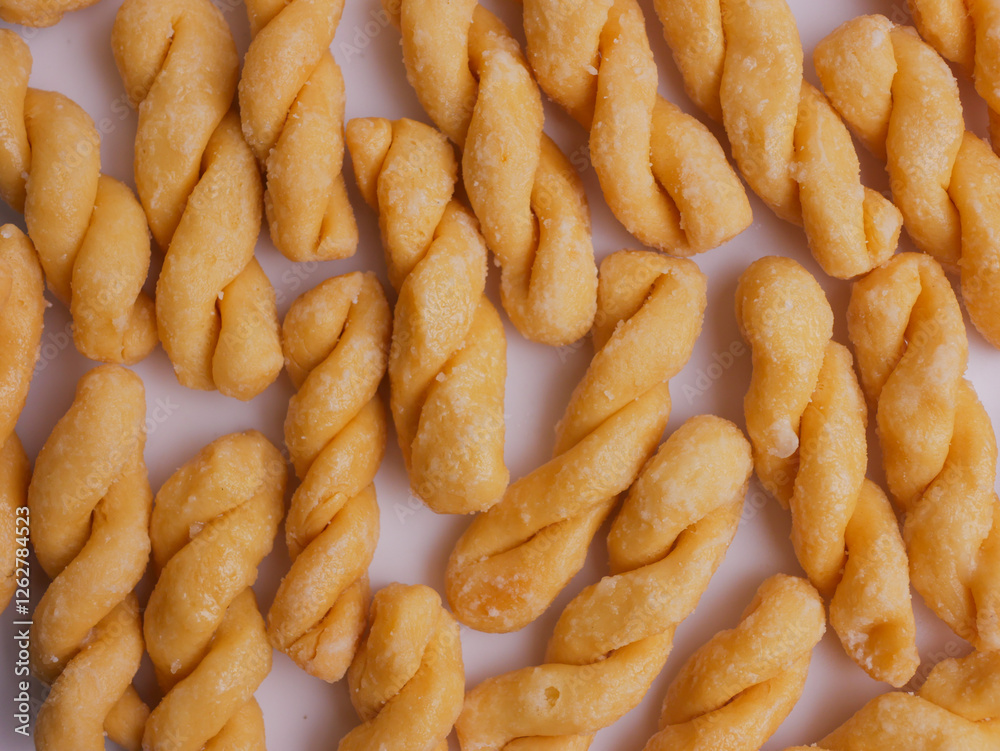 Kue untir-untir or kue tambang isolated on white background, untir untir is a traditional Indonesian deep-fried twisted doughnut that has a sweet and crunchy taste, snack, cookies, crispy, delicious Kue untir-untir or kue tambang isolated on white background, untir untir is a traditional Indonesian deep-fried twisted doughnut that has a sweet and crunchy taste, snack, cookies, crispy, delicious
