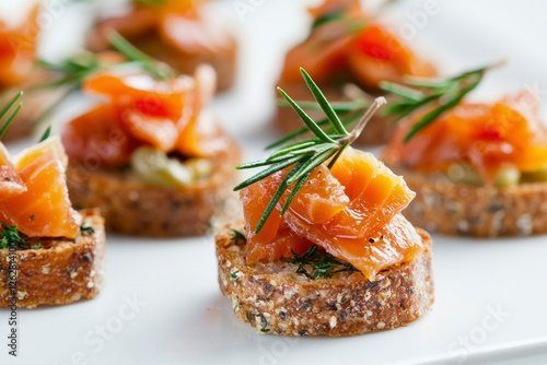 Appetizer platter of smoked salmon canapés on a white plate photo