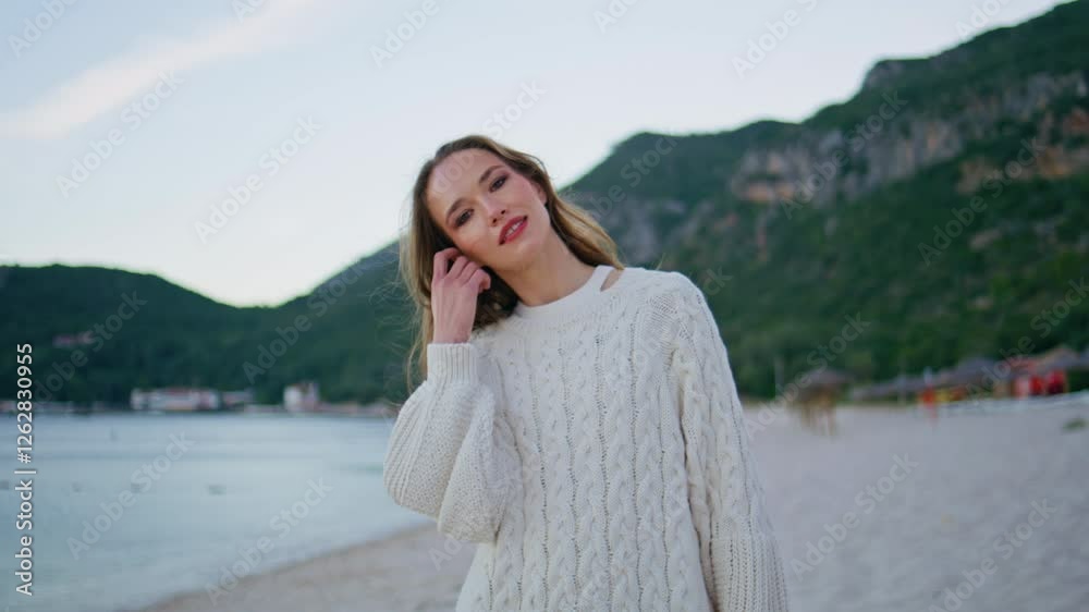Happy brunette enjoying beach nature at evening closeup. Attractive model posing Happy brunette enjoying beach nature at evening closeup. Attractive model posing