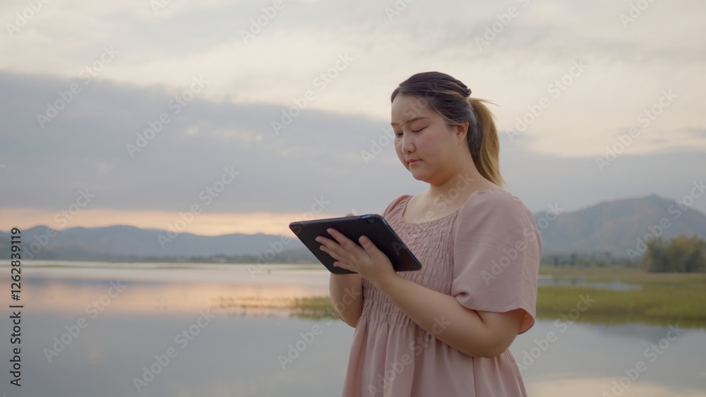 Naklejka premium Attractive Freelance Woman Relaxing and Working Remotely in Nature, work from anywhere , Learning Online. Digital nomad working remotely. social networks connected to 5g internet, Travel influencer