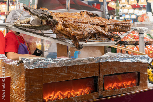 Grilled crocodile meat displayed for sale at a street food stall in Thailand.