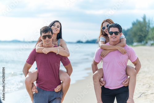 Obraz na płótnie Young woman and man group friends run and enjoy at the beach - summer vacation on sea beach concept w salonie