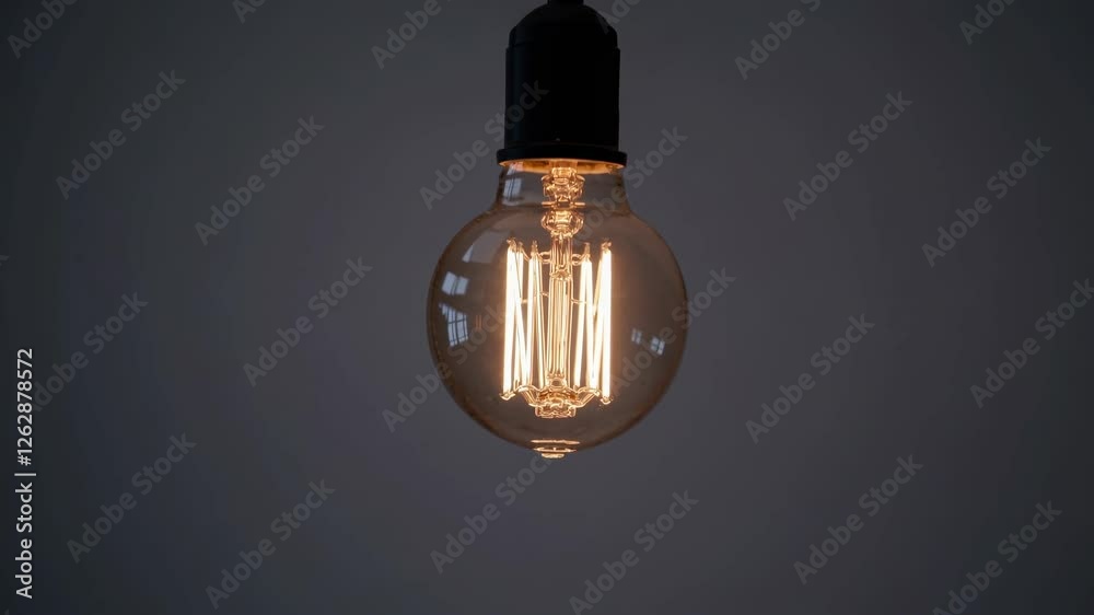 Minimalist video concept with a single hanging light bulb. Captured from a straight-on angle, highlighting simplicity and focus. Minimalist video concept with a single hanging light bulb. Captured from a straight-on angle, highlighting simplicity and focus.