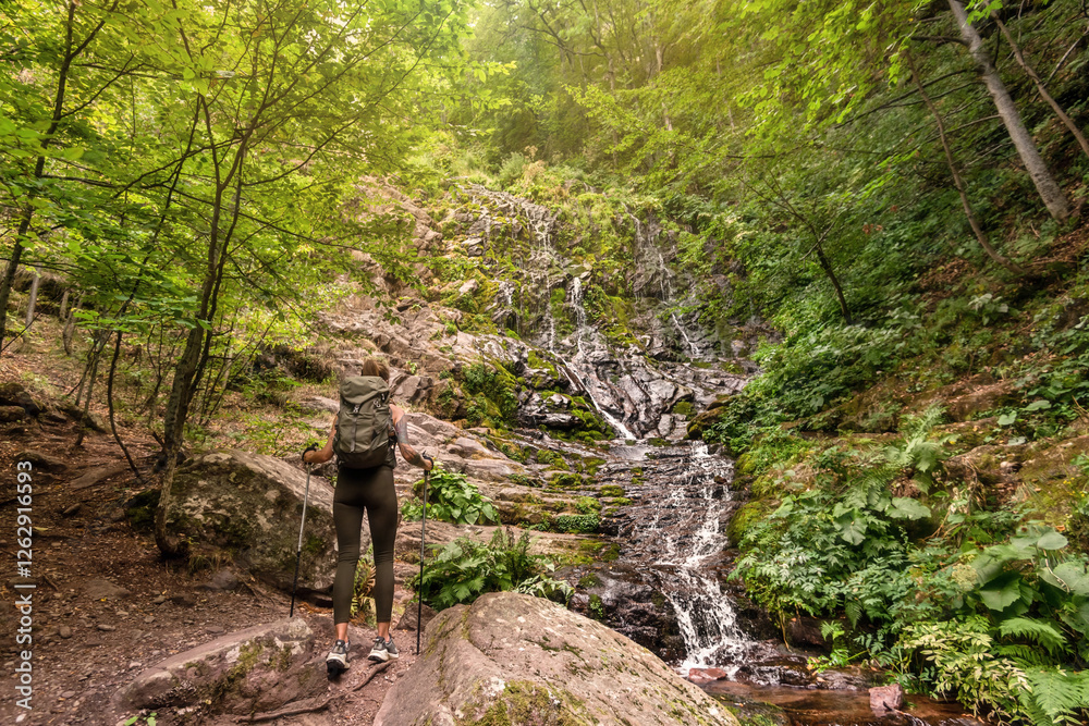 Woman Tourist Hiking in Mountain Forest with Waterfall