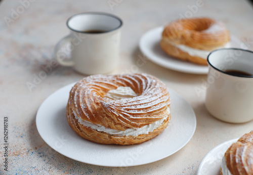 Cream puffs with whipped cream and sour cherries.