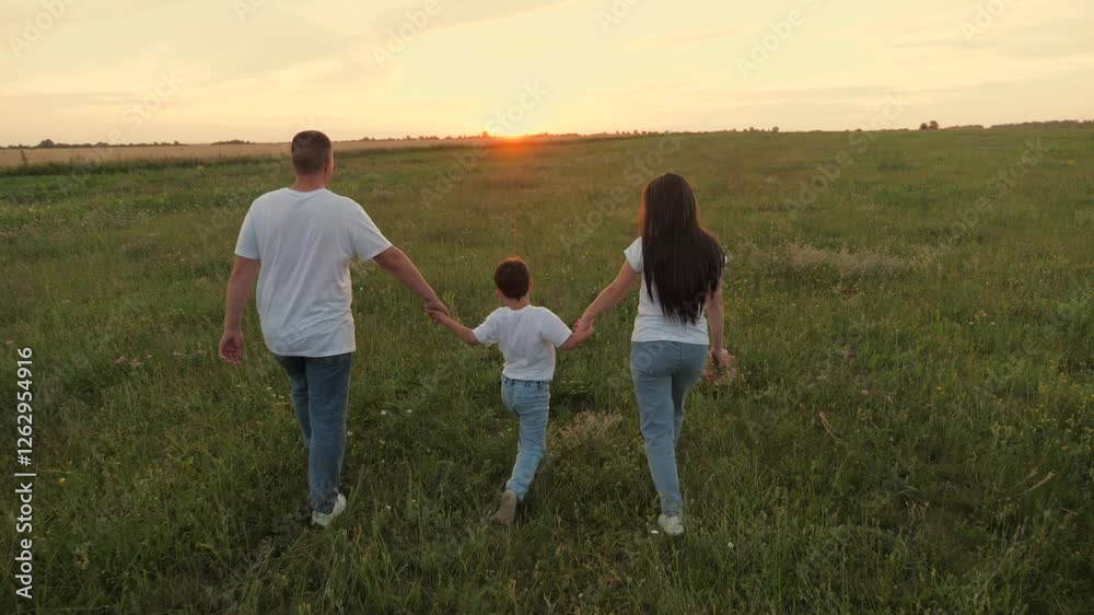 happy family walking sunset park, boy child father mother holding hands together walking green meadow, little son boy parents picnic, walk field sunset, view from back, man woman child holding hand happy family walking sunset park, boy child father mother holding hands together walking green meadow, little son boy parents picnic, walk field sunset, view from back, man woman child holding hand
