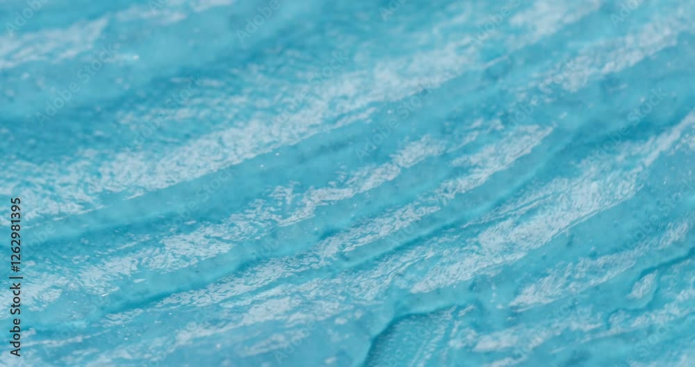 Transparent blue cosmetic gel texture close up. Abstract cosmetic background Transparent blue cosmetic gel texture close up. Abstract cosmetic background