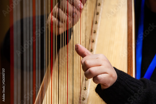 Close-up of a woman's hands playing the harp