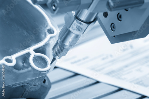 The automatic glue sealing process by robotic arm in the light blue scene.