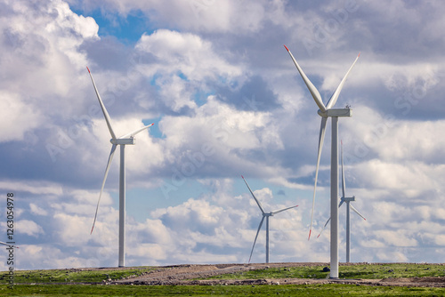 wind turbines in a field against a background of blue sky with clouds, wind farm, Kola peninsula, power plant, windmill