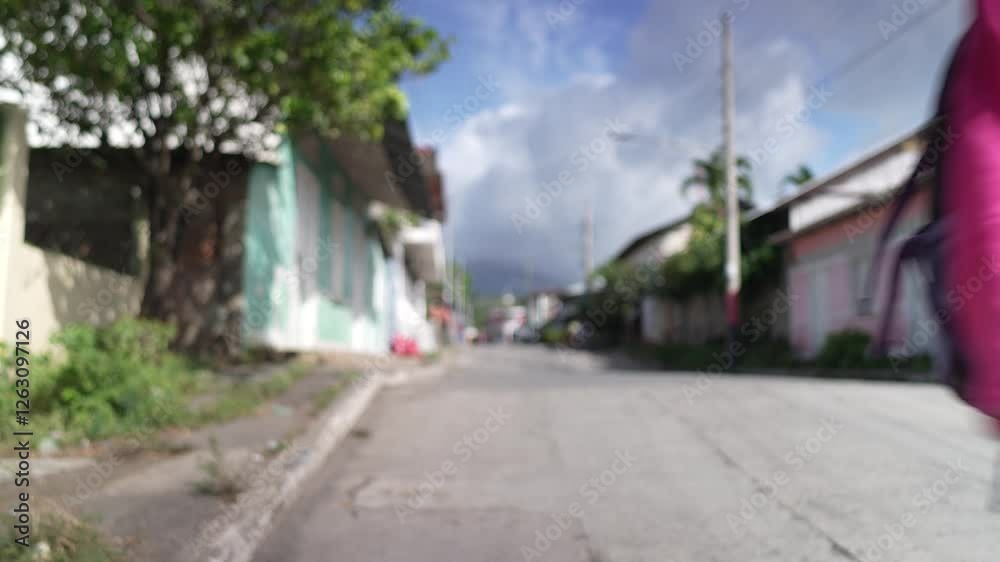 A happy woman strolls through the charming streets of Moyogalpa on Ometepe Island, Nicaragua, soaking in the vibrant atmosphere and scenic beauty. A happy woman strolls through the charming streets of Moyogalpa on Ometepe Island, Nicaragua, soaking in the vibrant atmosphere and scenic beauty.