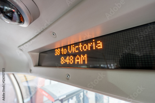 A digital display inside a city bus shows the route 38 to Victoria at 8:48 AM, This technology enhances the commuting experience by offering real-time updates on the route and schedule.