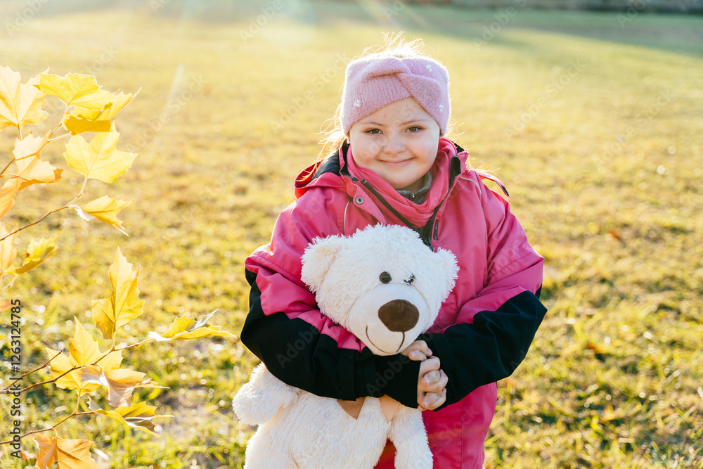 Girl with Special Needs Holding Teddy Bear in Autumn Light Girl with Special Needs Holding Teddy Bear in Autumn Light