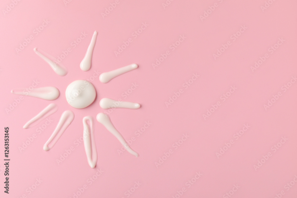 Sun shape made of cream on pink background, top view and space for text. Samples of cosmetic product Sun shape made of cream on pink background, top view and space for text. Samples of cosmetic product