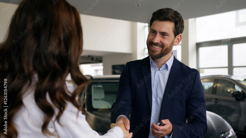 Woman female girl consultant trader give bunch of keys of new car automobile in showroom to man businessman guy business male client buyer buying luxury auto buy credit loan rent banking test drive Woman female girl consultant trader give bunch of keys of new car automobile in showroom to man businessman guy business male client buyer buying luxury auto buy credit loan rent banking test drive