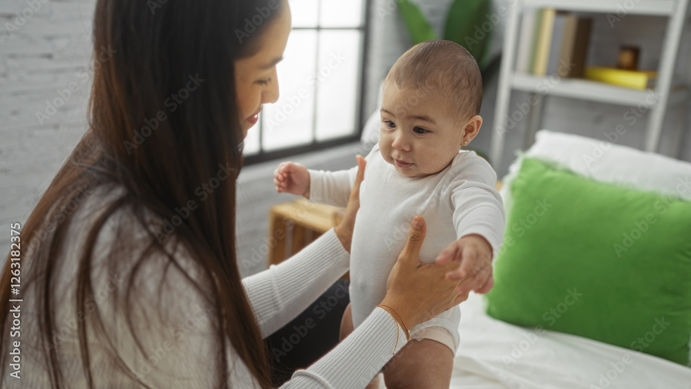 Woman holding baby lovingly in bedroom, capturing heartwarming family moment indoors with natural light, emphasizing mother and child connection in cozy home setting. Woman holding baby lovingly in bedroom, capturing heartwarming family moment indoors with natural light, emphasizing mother and child connection in cozy home setting.