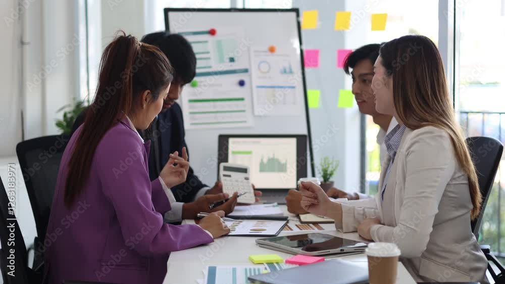 A group of people are gathered around a white board with a woman giving a presentation. Scene is positive and collaborative, as the group is clapping and smiling
A group of people are gathered around a white board with a woman giving a presentation. Scene is positive and collaborative, as the group is clapping and smiling