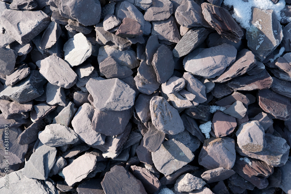 Textured stones scattered on the ground under bright sunlight Textured stones scattered on the ground under bright sunlight