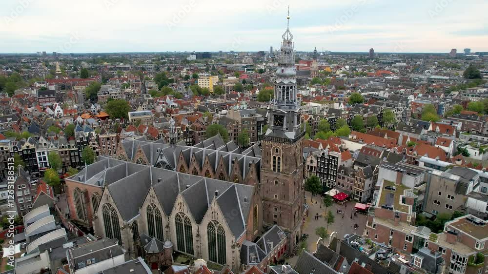 Stunning aerial shot of Oude Kerk Amsterdam showcasing its iconic canals, historic architecture, and vibrant cityscape. 