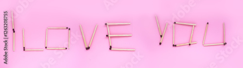 I love you, the inscription is laid out with matches on a pink background. Banner, background with a romantic inscription.