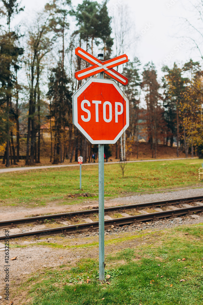 The sign of a stop at a railway crossing. A red mark on a railway station