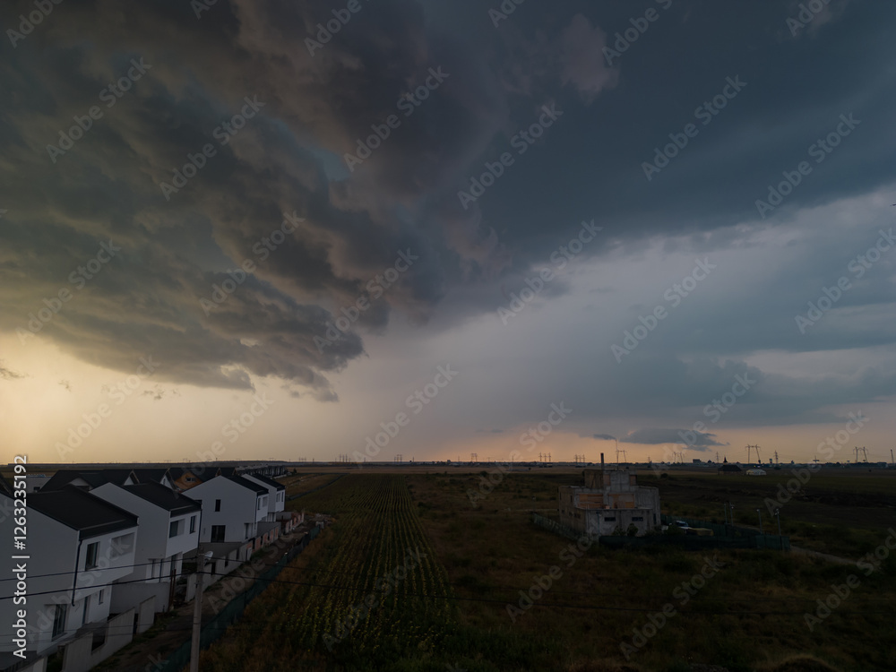 Rural settlement on the plain filmed from drone in cloudy summer weather. Beginning of a strong storm accompanied by thunder and lightning Rural settlement on the plain filmed from drone in cloudy summer weather. Beginning of a strong storm accompanied by thunder and lightning