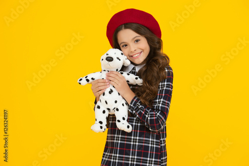 Teen girl back to school. Education in childhood. Student in uniform isolated on yellow. September 1. Happy childhood. School girl in uniform play toy. Autumn time for school photo