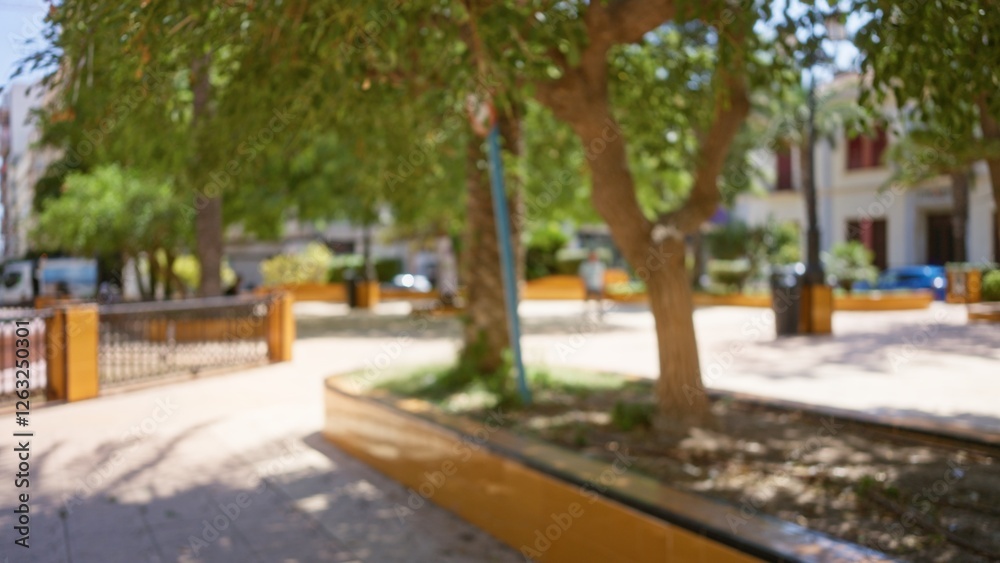 Blurry park background with trees and defocused people during a sunny day creating a vibrant bokeh effect Blurry park background with trees and defocused people during a sunny day creating a vibrant bokeh effect