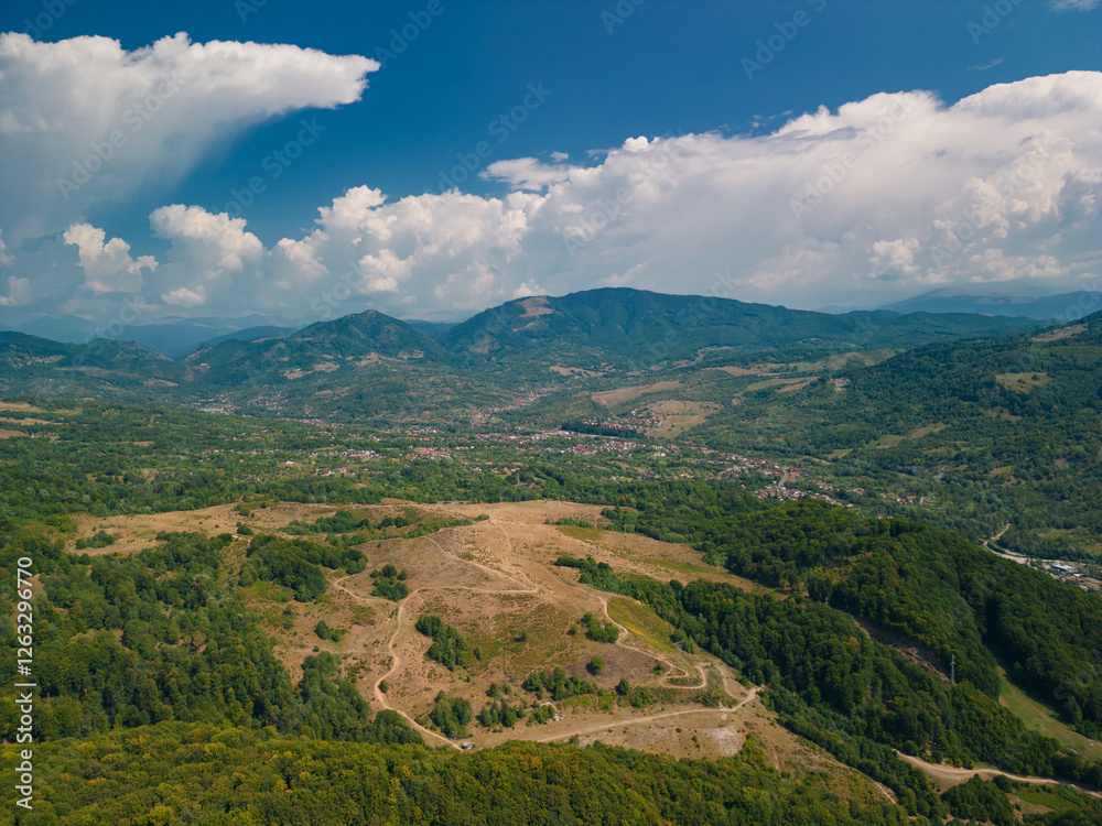 Fototapeta premium Picturesque landscape with high hills and forests at the foot of the Carpathian Mountains in sunny weather in summer season