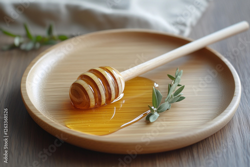 Perfectly polished wooden plate featuring golden honey drizzled beside a wooden honey dipper and fresh herbs on a rustic wooden surface photo