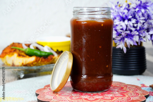 Imli ki Chutney, Tamarind sauce, Sauce in glass bottle                                                           photo