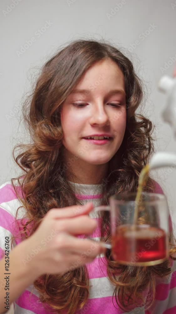 Vertical video of a girl with wavy hair enjoying a tea moment Vertical video of a girl with wavy hair enjoying a tea moment