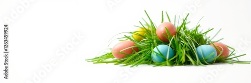 Colorful Easter eggs with a festive mood resting in fresh grass against a white background photo