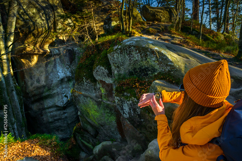 Over the shoulder view of Female Checking Current Altitudeon Casio Wrist Watch While Exploring a Cave in a Canyon photo