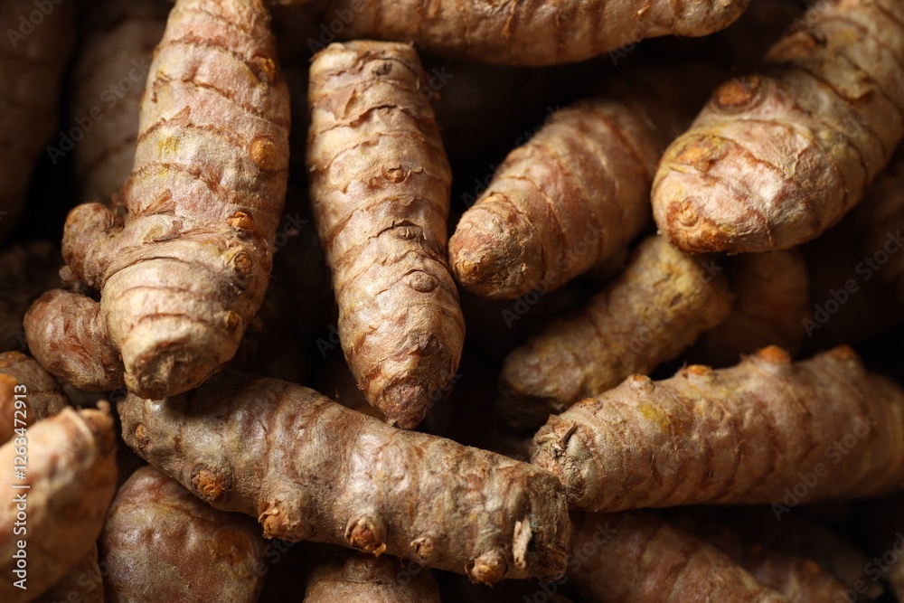Many fresh turmeric roots as background, above view Many fresh turmeric roots as background, above view