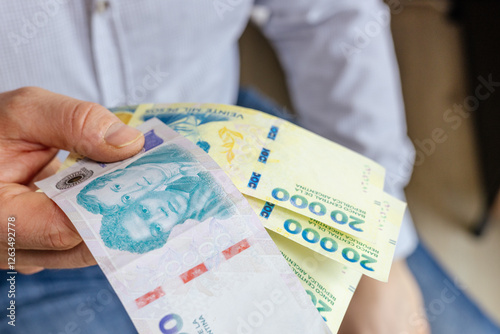 Obraz na płótnie Argentina new banknotes. businessman holding argentine pesos in hand. 10 and 20 thousand, big cash. financial business concept. economic growth w salonie