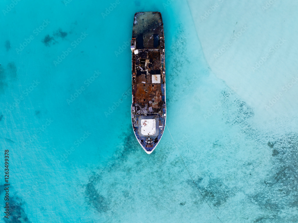 Aerial view of a half sunken ship at Maldives, Indian ocean. Big rusty ship is on this photo in a lagoon.